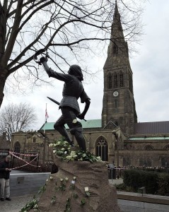 The statue of Richard III at Leicester Cathedral, with white roses