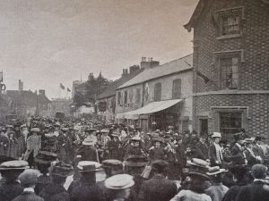 The 1907 procession showing, on the cottages, some of the decorative shields 